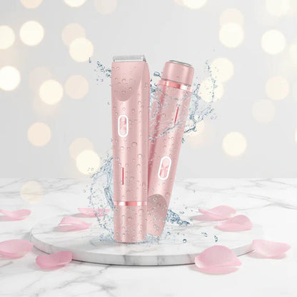 Two pink hair clippers on a marble surface with blurred lights in the background